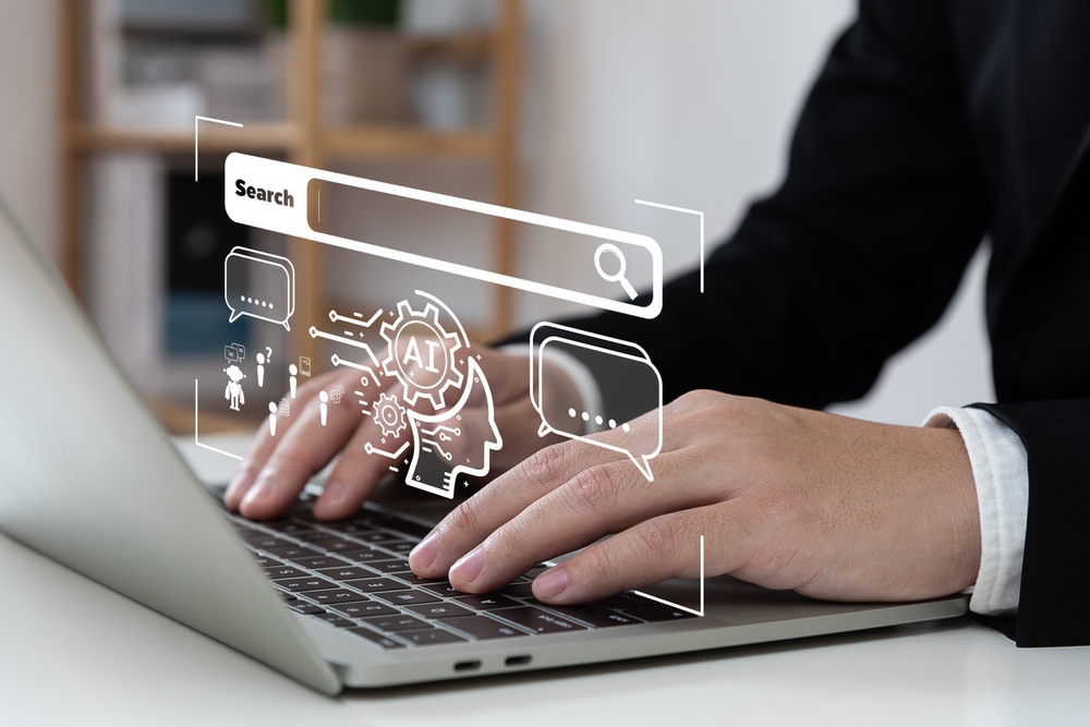 man typing at laptop